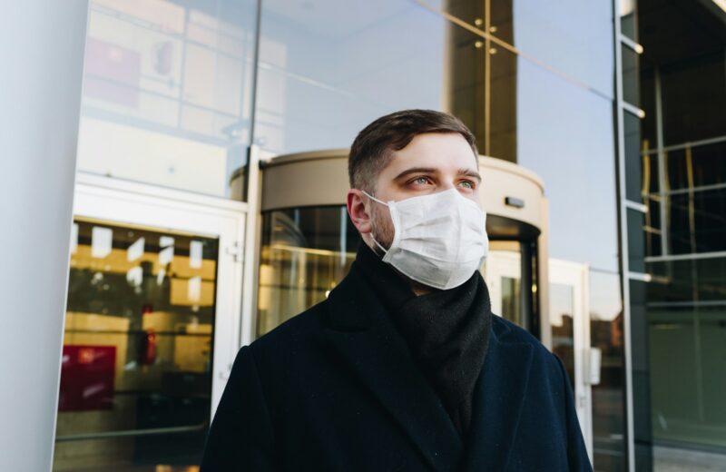 man in black robe wearing white face mask